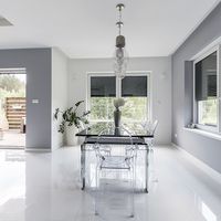 Light and modern living room Modern living room with many windows and transparent plastic chairs